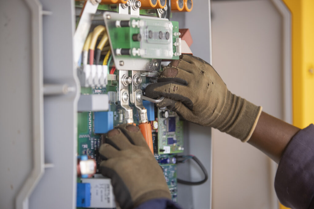 An engineer works on a power connection at Powerhive in Kisii.