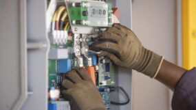 An engineer works on a power connection at Powerhive in Kisii.